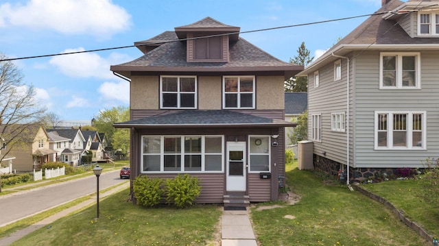 601 N 22nd Ave W, Duluth, MN 55806 - american foursquare style home with entry steps, a front lawn, a shingled roof, and stucco siding
