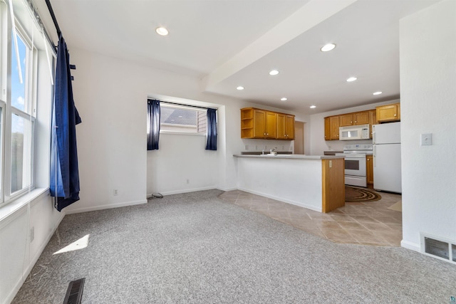 601 N 22nd Ave W, Duluth, MN 55806 - kitchen featuring white appliances, light colored carpet, recessed lighting, a peninsula, and open shelves