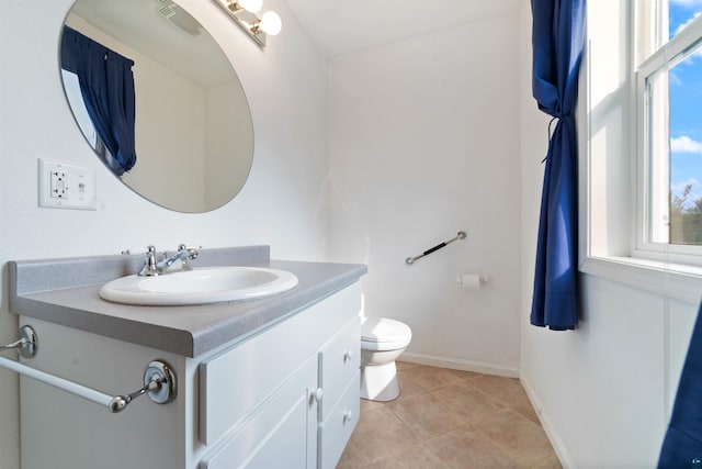 601 N 22nd Ave W, Duluth, MN 55806 - bathroom featuring vanity, toilet, tile patterned floors, and baseboards