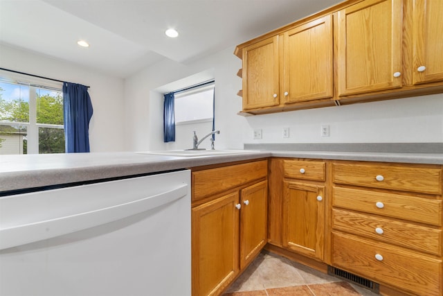 601 N 22nd Ave W, Duluth, MN 55806 - kitchen featuring white dishwasher, a sink, recessed lighting, light countertops, and brown cabinets