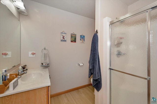 1505 Coachlight Crk, Proctor, MN 55810 - bathroom with wood finished floors, vanity, a stall shower, and baseboards