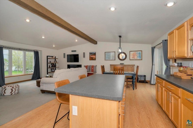 1505 Coachlight Crk, Proctor, MN 55810 - kitchen with dark countertops, a center island, light wood finished floors, recessed lighting, and a breakfast bar