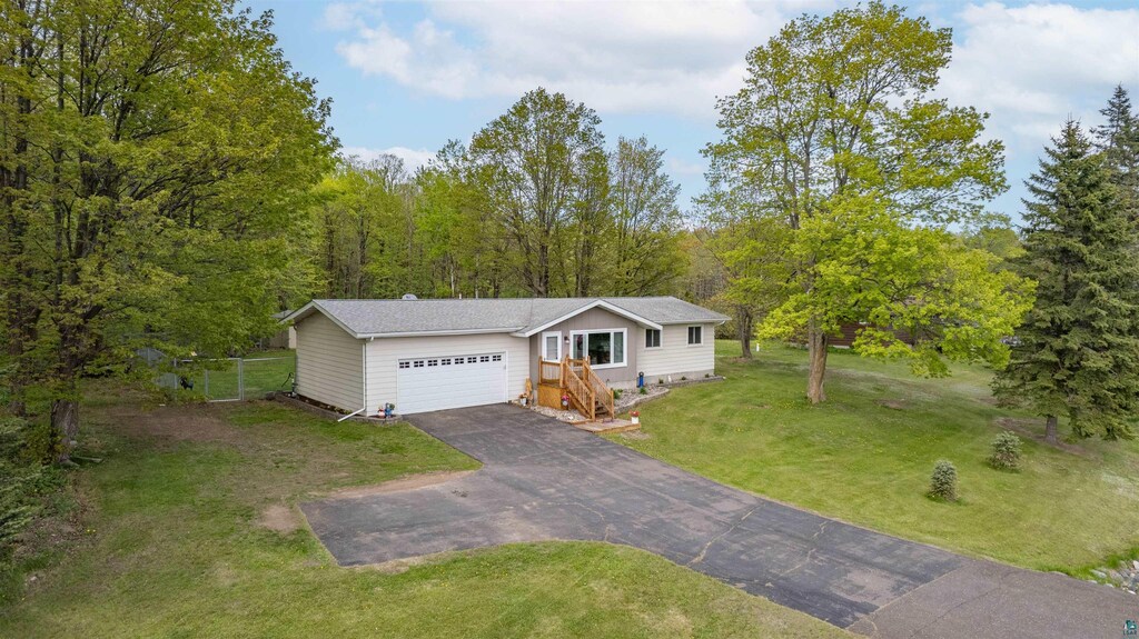 9211 W Skyline Pkwy, Duluth, MN 55810 - view of front of home with asphalt driveway and a garage