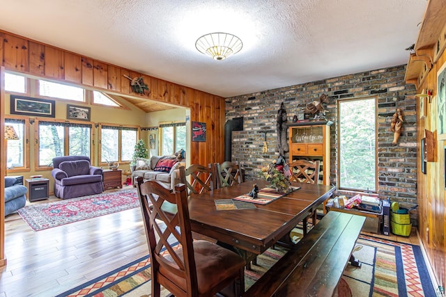 3984 Stocking Point Dr, Ely, MN 55731 - dining space featuring a textured ceiling, wood finished floors, and vaulted ceiling
