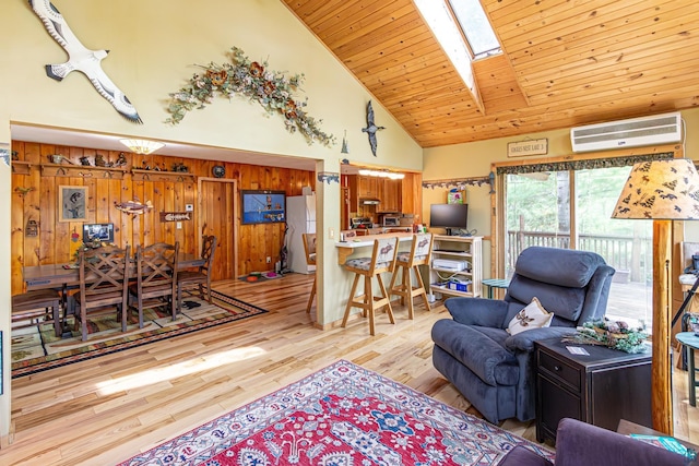 3984 Stocking Point Dr, Ely, MN 55731 - living area with an AC wall unit, wood finished floors, high vaulted ceiling, a skylight, and wooden ceiling
