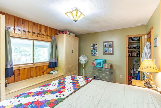 3984 Stocking Point Dr, Ely, MN 55731 - bedroom featuring a textured ceiling and wood walls