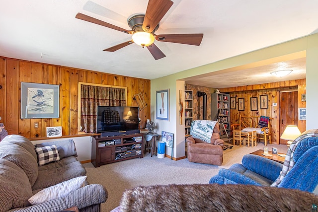 3984 Stocking Point Dr, Ely, MN 55731 - carpeted living area featuring wood walls, baseboards, and ceiling fan
