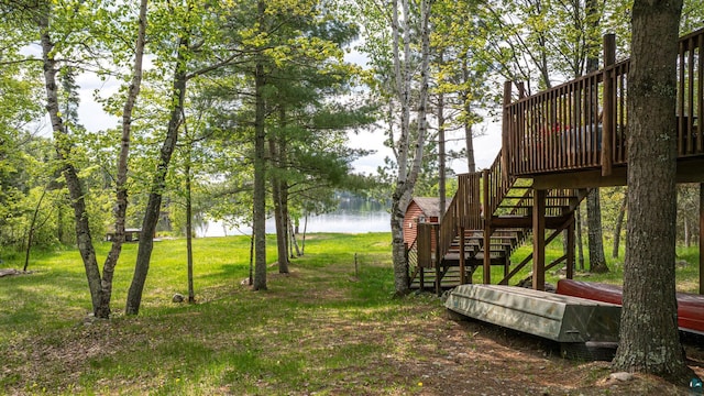 3984 Stocking Point Dr, Ely, MN 55731 - view of grassy yard with stairs and a deck with water view