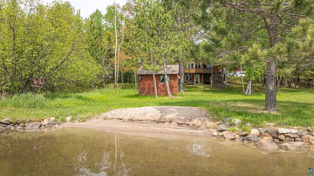 3984 Stocking Point Dr, Ely, MN 55731 - view of grassy yard with stairway, a deck, and an outdoor structure
