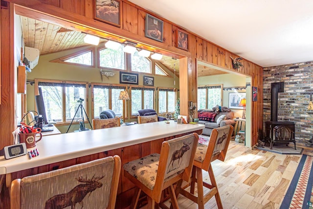 3984 Stocking Point Dr, Ely, MN 55731 - dining space with light wood-style floors, a wood stove, healthy amount of natural light, and lofted ceiling