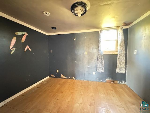 3217 Vermilion Trl, Makinen, MN 55763 - spare room with wood finished floors and ornamental molding