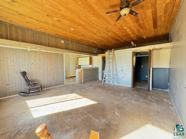 3217 Vermilion Trl, Makinen, MN 55763 - unfurnished living room featuring wooden ceiling, concrete flooring, a ceiling fan, and wooden walls