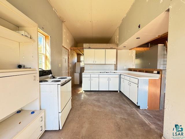 3217 Vermilion Trl, Makinen, MN 55763 - kitchen featuring white range with electric stovetop, concrete flooring, white cabinetry, and light countertops