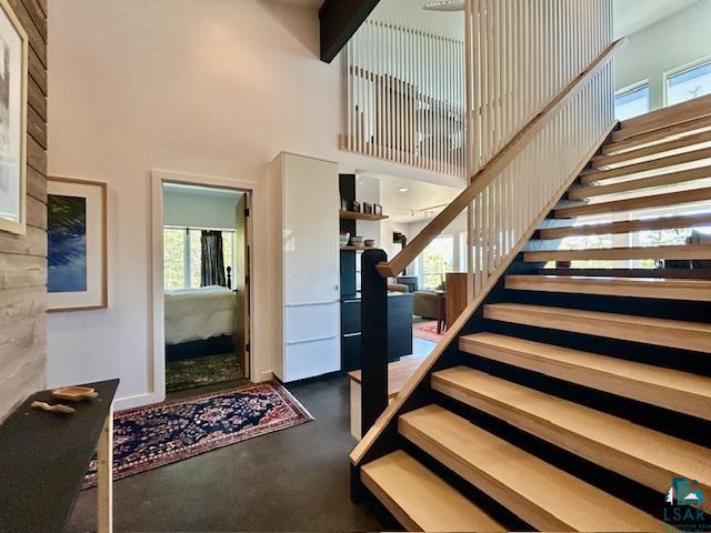 328 Gunflint Trl, Grand Marais, MN 55604 - staircase featuring a high ceiling and finished concrete floors