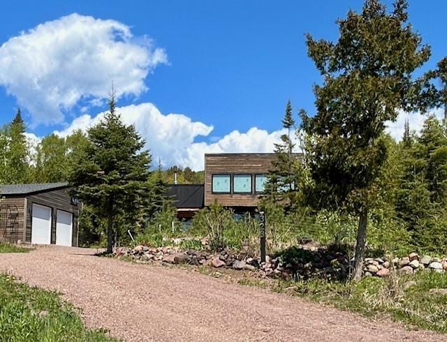 328 Gunflint Trl, Grand Marais, MN 55604 - view of front of property with dirt driveway and a garage
