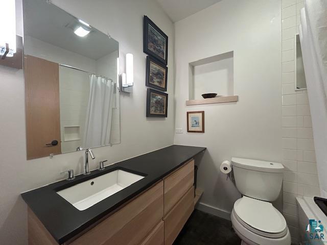 328 Gunflint Trl, Grand Marais, MN 55604 - full bath with vanity, a shower with shower curtain, and toilet