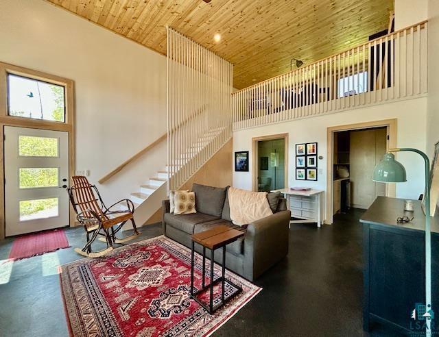 328 Gunflint Trl, Grand Marais, MN 55604 - living area with wooden ceiling, plenty of natural light, a towering ceiling, and stairs