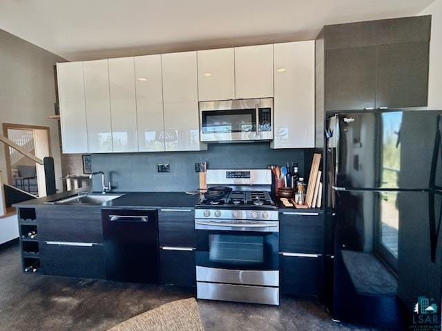 328 Gunflint Trl, Grand Marais, MN 55604 - kitchen with stainless steel appliances, a sink, white cabinets, modern cabinets, and concrete floors