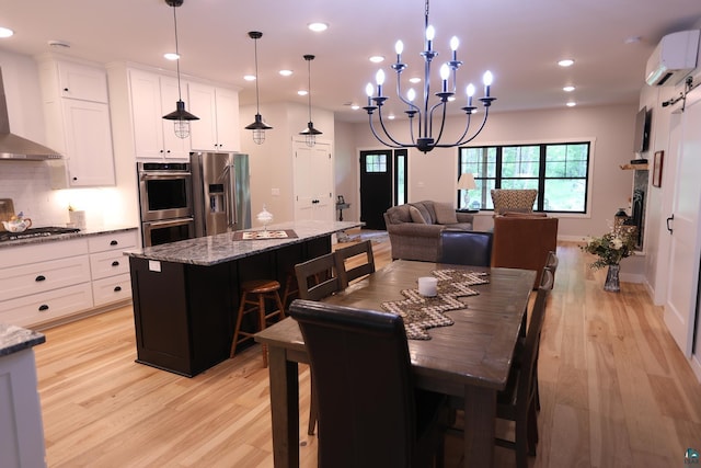 5004 W Rd, Moose Lake, MN 55767 - dining area with a wall unit AC, light wood-type flooring, recessed lighting, and a chandelier