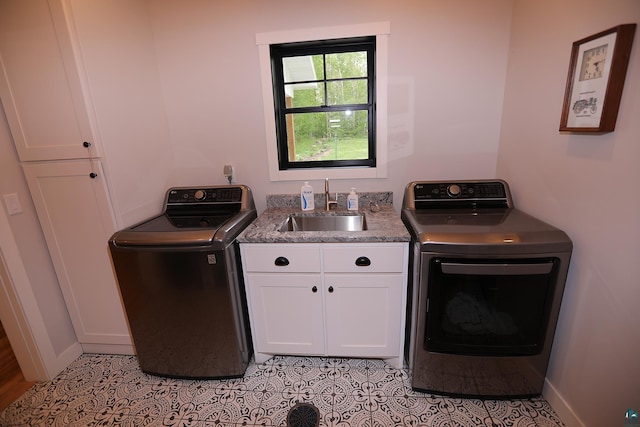 5004 W Rd, Moose Lake, MN 55767 - washroom featuring cabinet space, baseboards, light tile patterned floors, and washer and dryer