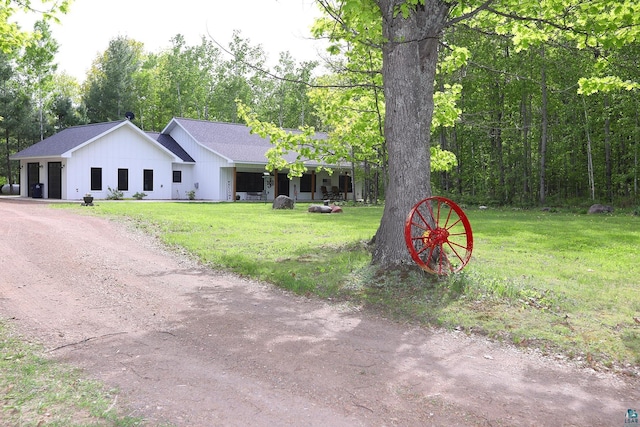 5004 W Rd, Moose Lake, MN 55767 - view of front of property featuring a front yard, board and batten siding, and driveway