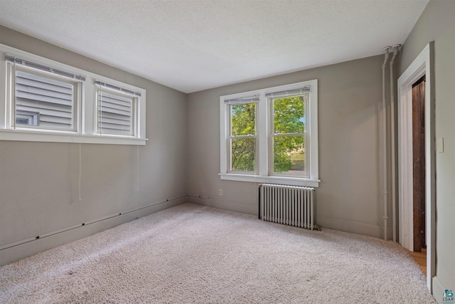 620 Hayes St, Eveleth, MN 55734 - empty room featuring radiator heating unit, carpet, and a textured ceiling