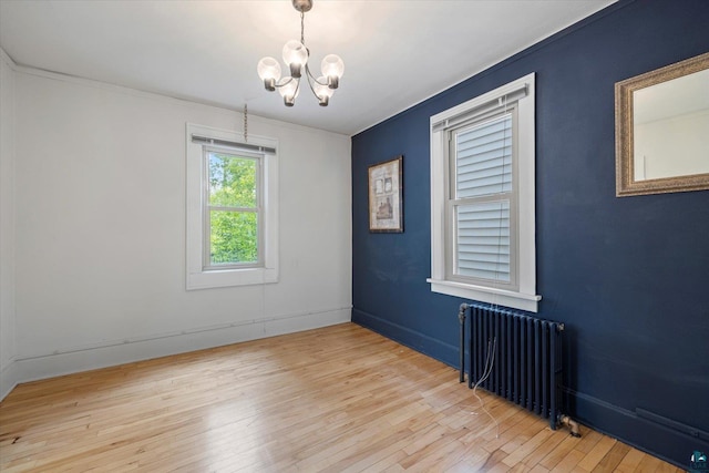 620 Hayes St, Eveleth, MN 55734 - spare room featuring radiator, a chandelier, hardwood / wood-style floors, baseboards, and ornamental molding