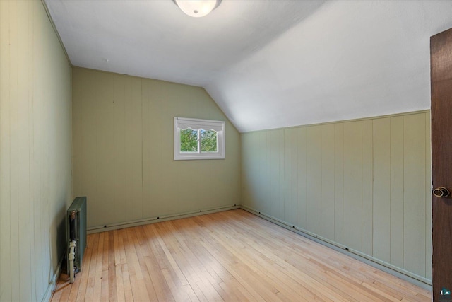 620 Hayes St, Eveleth, MN 55734 - bonus room featuring hardwood / wood-style floors, radiator, lofted ceiling, and wooden walls