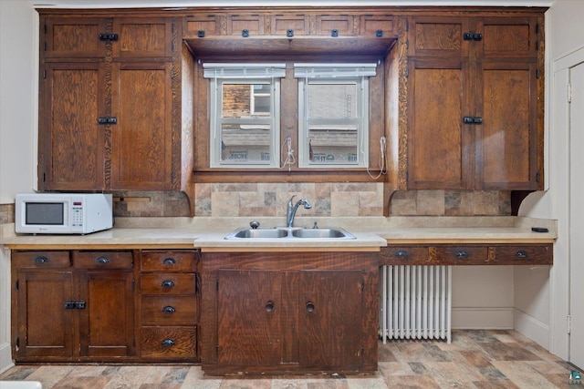 620 Hayes St, Eveleth, MN 55734 - kitchen with radiator heating unit, white microwave, a sink, baseboards, and light countertops