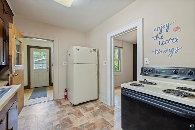 620 Hayes St, Eveleth, MN 55734 - kitchen featuring electric range oven, freestanding refrigerator, stone finish floors, and light countertops