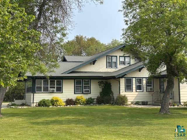 1601 W 4th Ave, International Falls, MN 56649 - view of front of house featuring a front yard and cooling unit