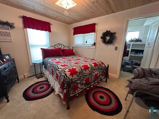 1601 W 4th Ave, International Falls, MN 56649 - carpeted bedroom with wooden ceiling, a baseboard radiator, baseboards, and ornamental molding