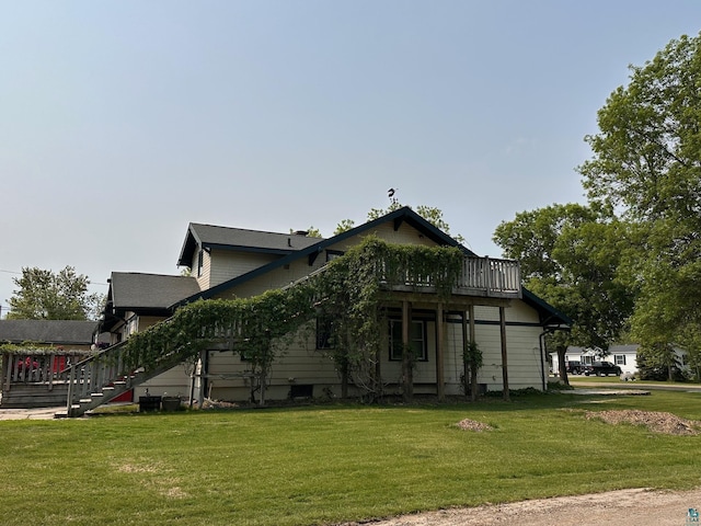 1601 W 4th Ave, International Falls, MN 56649 - view of home's exterior featuring stairs, a lawn, and a deck