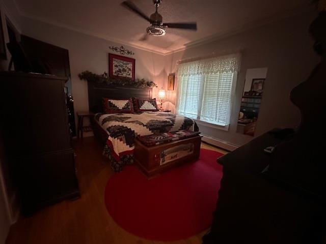 1601 W 4th Ave, International Falls, MN 56649 - bedroom featuring wood finished floors, ornamental molding, a ceiling fan, and a baseboard radiator
