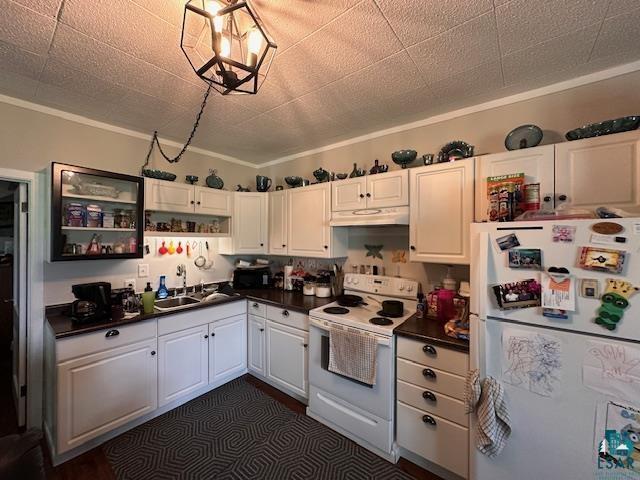 1601 W 4th Ave, International Falls, MN 56649 - kitchen with white appliances, a sink, under cabinet range hood, dark countertops, and white cabinetry