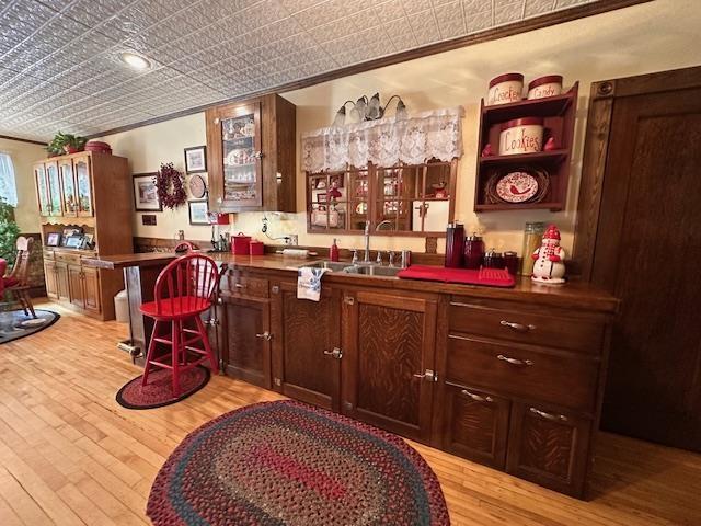 1601 W 4th Ave, International Falls, MN 56649 - bar featuring an ornate ceiling, light wood-style floors, ornamental molding, and a sink