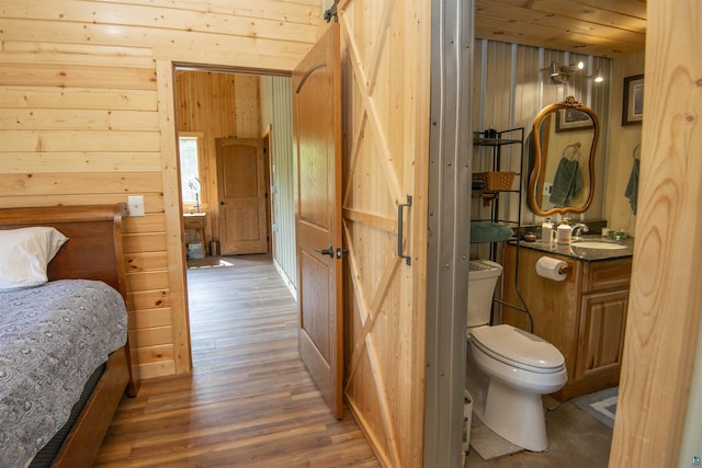 72 Sled Dog Trl, Hovland, MN 55604 - bedroom with wood finished floors, wooden walls, and a sink