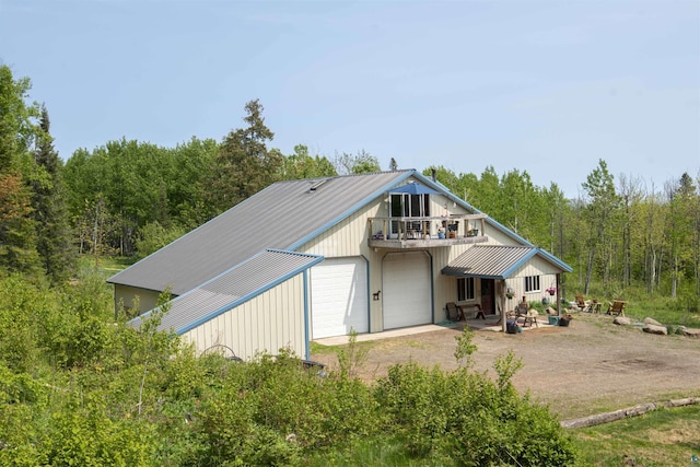 72 Sled Dog Trl, Hovland, MN 55604 - view of front facade featuring a balcony, dirt driveway, and a view of trees