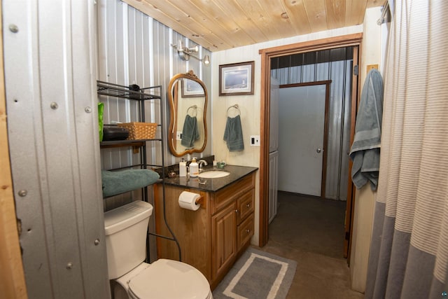 72 Sled Dog Trl, Hovland, MN 55604 - bathroom featuring vanity, toilet, concrete floors, and wooden ceiling