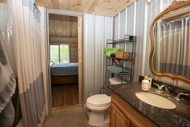 72 Sled Dog Trl, Hovland, MN 55604 - ensuite bathroom with vanity, toilet, wood ceiling, concrete flooring, and curtained shower