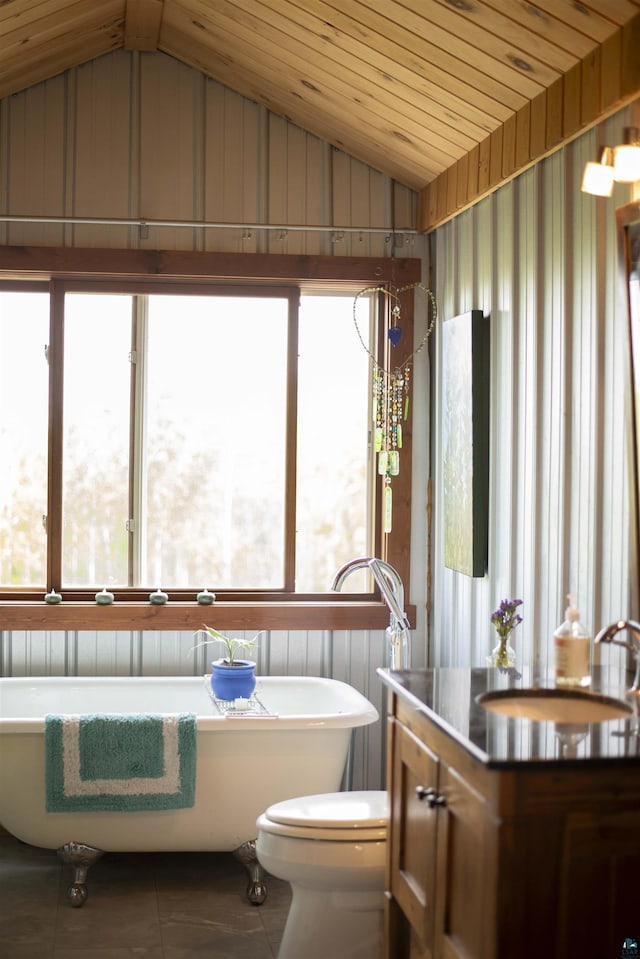 72 Sled Dog Trl, Hovland, MN 55604 - full bath with lofted ceiling, a sink, tile patterned flooring, a freestanding tub, and toilet