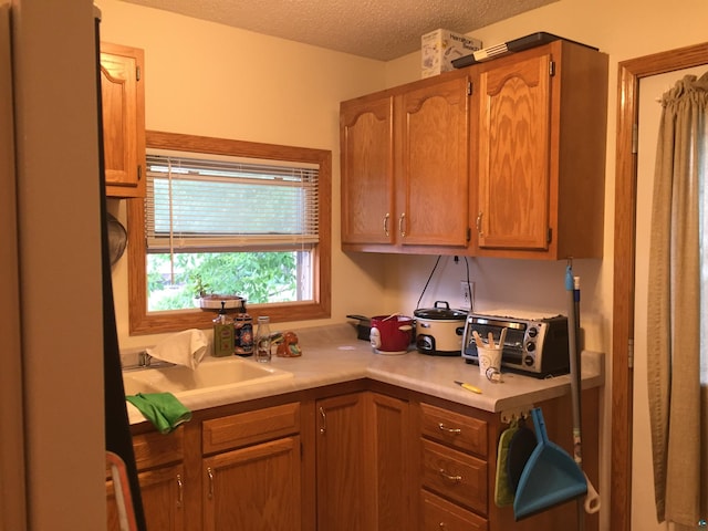 2213 W 10th St, Duluth, MN 55806 - kitchen with light countertops, a textured ceiling, and a sink