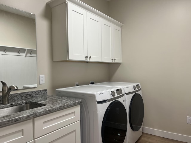5036 W Arrowhead Rd, Hermantown, MN 55811 - laundry room featuring cabinet space, washer and dryer, and wood finished floors