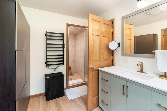4409 Cedarway Rd, Duluth, MN 55810 - bathroom with radiator, vanity, a shower stall, a towel warmer, and wood finished floors