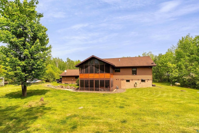 4409 Cedarway Rd, Duluth, MN 55810 - back of property with a sunroom, a yard, and roof with shingles