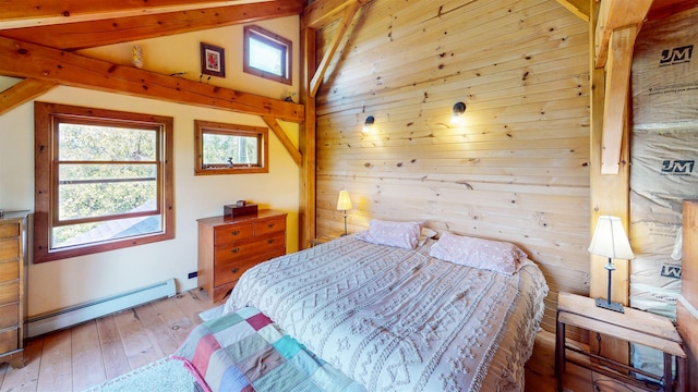 815 Otter Lake Rd, Hovland, MN 55606 - bedroom with a baseboard radiator, wooden walls, and hardwood / wood-style flooring