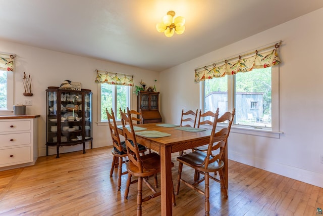 1 W Railroad St, Ely, MN 55731 - dining room featuring light wood-style flooring, baseboards, and a chandelier