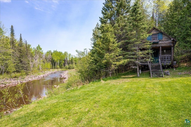 115 Copperhead Rd, Knife River, MN 55616 - view of grassy yard with stairway and a wooded view