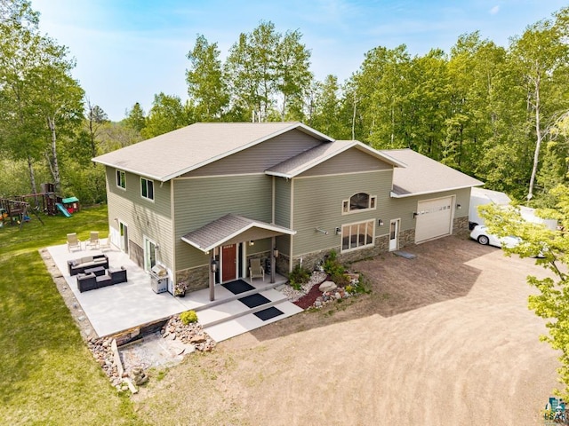 5386 Martin Rd, Duluth, MN 55811 - view of front facade featuring stone siding, an attached garage, outdoor lounge area, a front yard, and dirt driveway