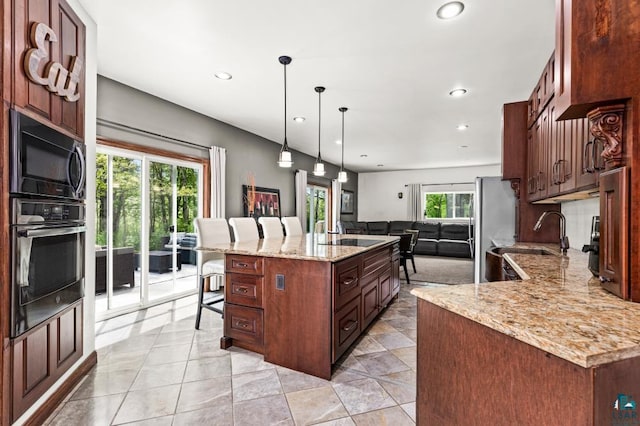5386 Martin Rd, Duluth, MN 55811 - kitchen with appliances with stainless steel finishes, a kitchen breakfast bar, open floor plan, recessed lighting, and light stone counters